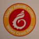 White dragon-tailed seashell on red background within yellow circlet.