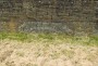 Mill stone in the wall of the reservoir